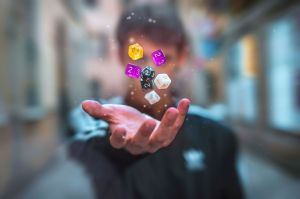 close up shot of a human hand throwing dice into the air